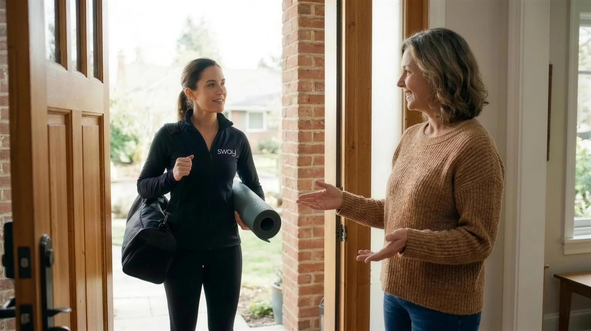 A Sway coach arriving at a client's home, welcomed at the door